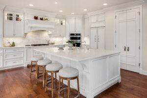 white kitchen with brown wood floors