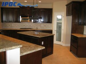 Renovated kitchen with dark brown cabinets and tan countertops.