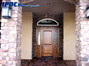 Front door to residence with stone columns