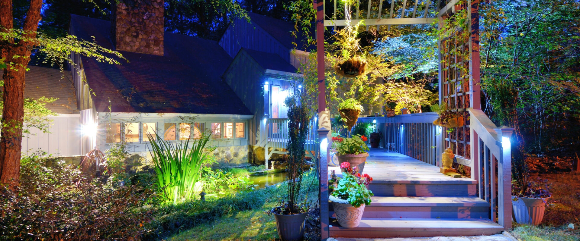 Walkway and front porch of a nice house in the woods.